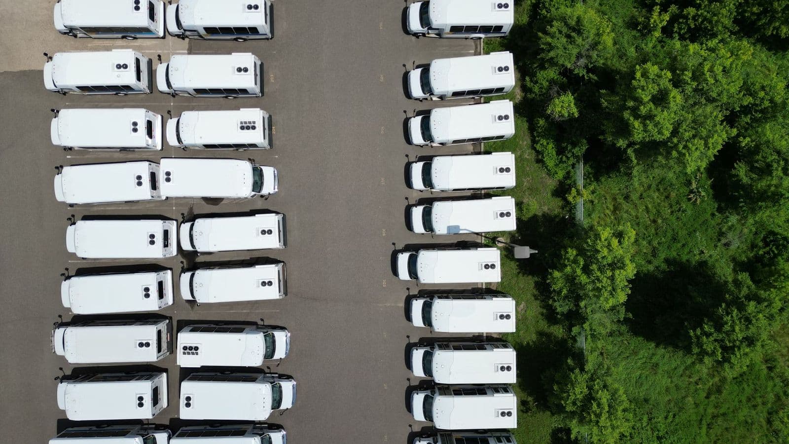 Coaches lined up at a venue entrance for event guest transport